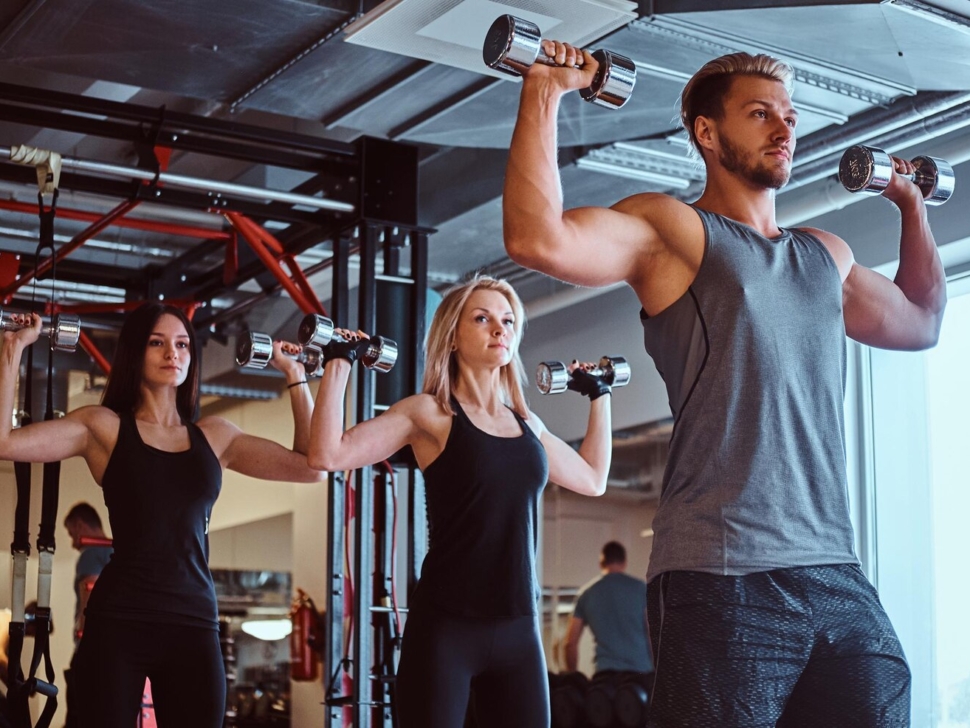 group-people-exercising-with-dumbbells-fitness-club-gym_613910-18611